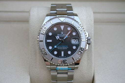 Rolex 268622 | SD Watches Rolex YachtβMaster stainless steel watch on a beige cushion with a black dial and date window at 3 o'clock.