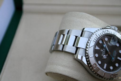 IMG_7449 | SD Watches Close-up of a silver Rolex wristwatch with a black dial resting on a beige cushion.