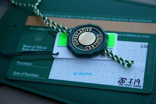 IMG_7459 | SD Watches Close-up of a Rolex Superlative Certified seal attached to a green purchase card inside a watch box.