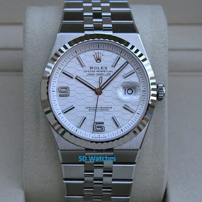 Rolex 127334 | SD Watches Close-up of a stainless steel Rolex watch with a fluted bezel, white patterned dial, and date window at 3 o'clock.