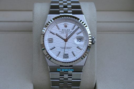 Rolex 127334 | SD Watches Close-up of a stainless steel Rolex watch with a fluted bezel, white patterned dial, and date window at 3 o'clock.