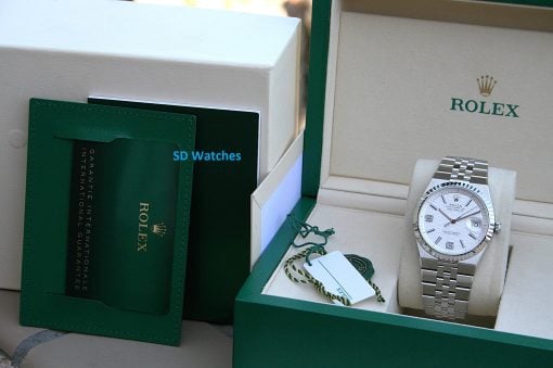 IMG_7494 | SD Watches Rolex watch in an open green box with white interior and accompanying paperwork/badges visible on the left side.