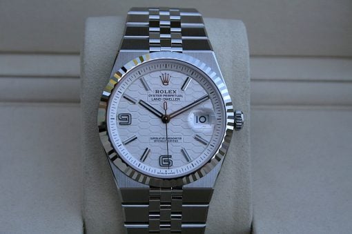 IMG_7497 | SD Watches Close-up of a Rolex Oyster Perpetual Land-Dweller wristwatch with a white patterned dial, date window at 3 o'clock, and stainless-steel bracelet.