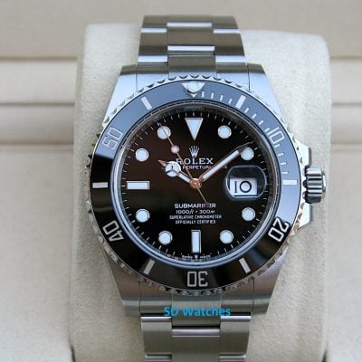Rolex 126610 | SD Watches Close-up of a stainless steel Rolex Submariner dive watch with a black dial on a light cushion.