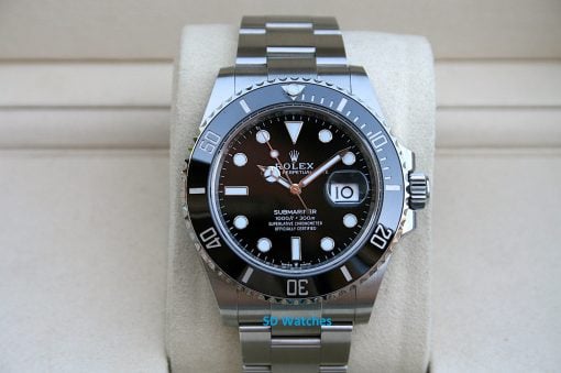 Rolex 126610 | SD Watches Close-up of a stainless steel Rolex Submariner dive watch with a black dial on a light cushion.