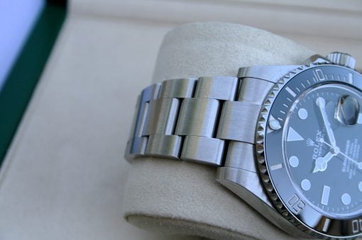 IMG_7507 | SD Watches Close-up of a silver Rolex diver's watch with a brushed steel bracelet resting on a soft cushion.