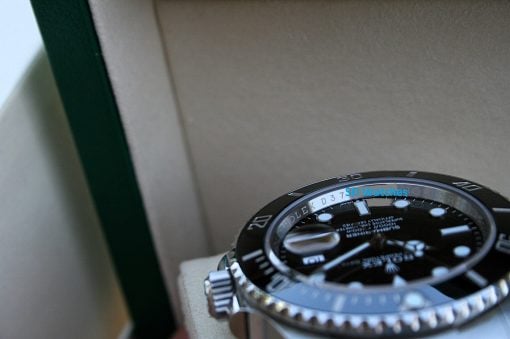 IMG_7512 | SD Watches Close-up of a stainless steel watch with a black dial and rotating bezel; blue 'SD Watches' watermark across the face.