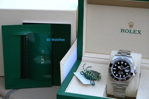 IMG_7514 | SD Watches Rolex watch displayed in an open green box with accompanying tags and paperwork visible inside the box